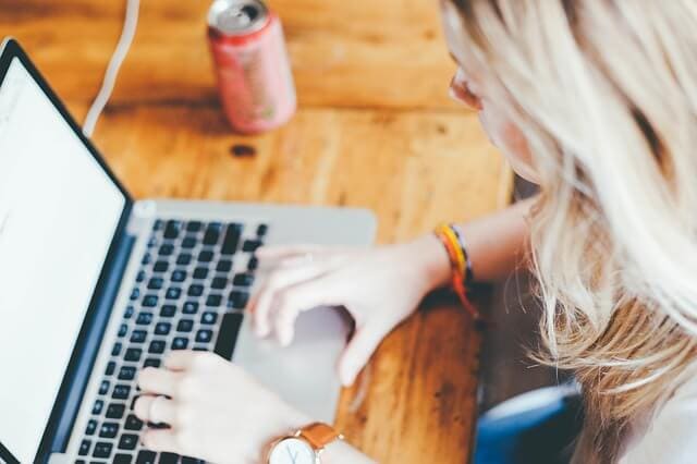 women typing on a laptop